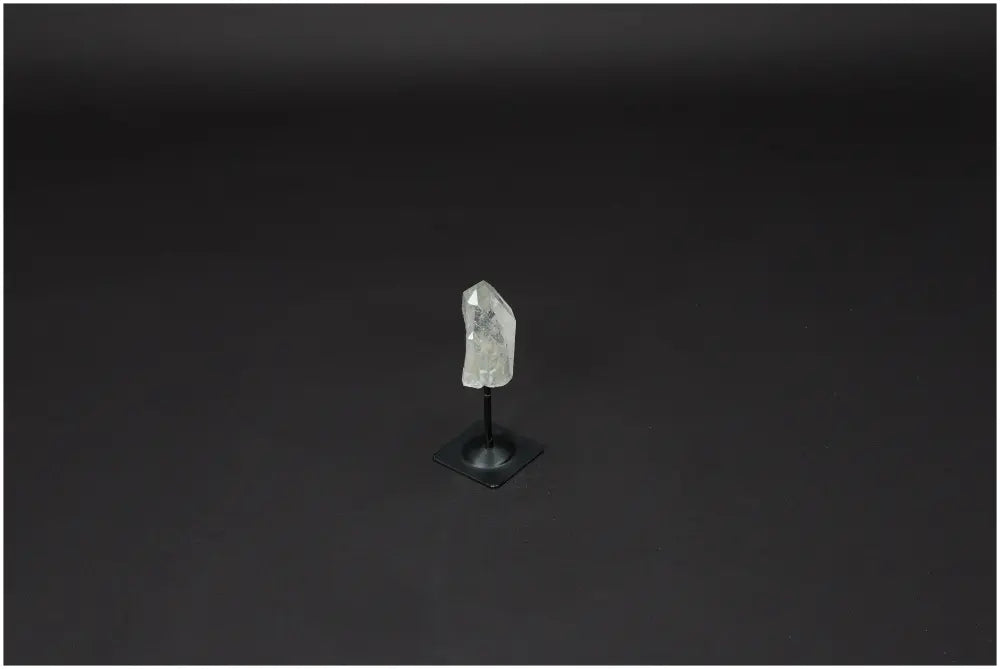 Lemurian Quartz crystal on metal stand, known as Master Healer, promotes clarity and balance in personal growth and well-being.