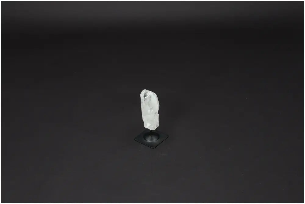 Lemurian Clear Quartz crystal on metal stand for clarity and balance, ethically sourced and naturally formed for personal growth.