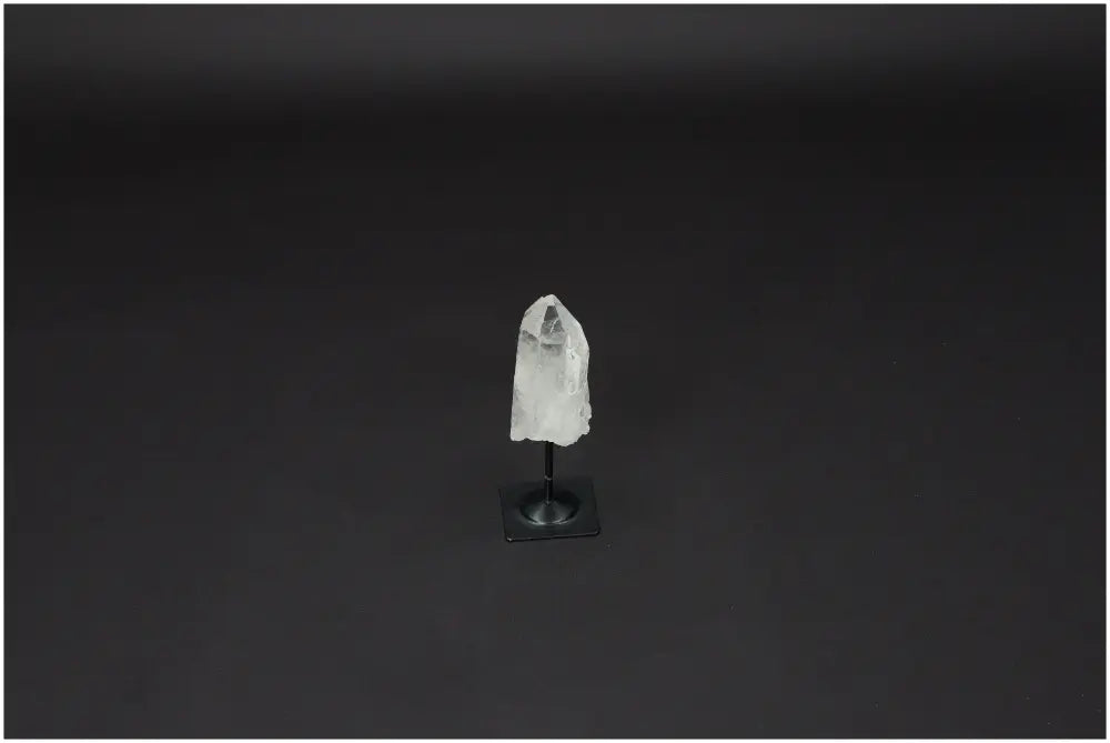 Lemurian Quartz on metal stand with a dark background, ideal for harmonizing body and energy by neutralizing negative vibrations.