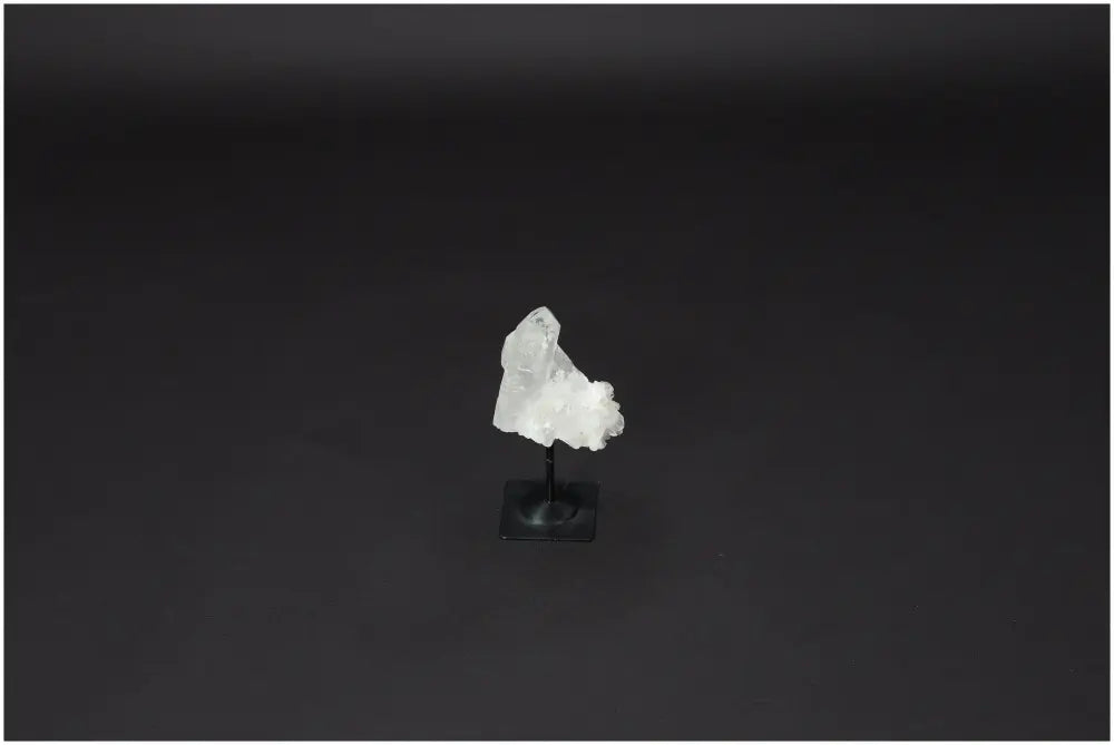 Lemurian Quartz on a metal stand, featuring clear quartz known for purification, harmonizing energy, and neutralizing negativity.