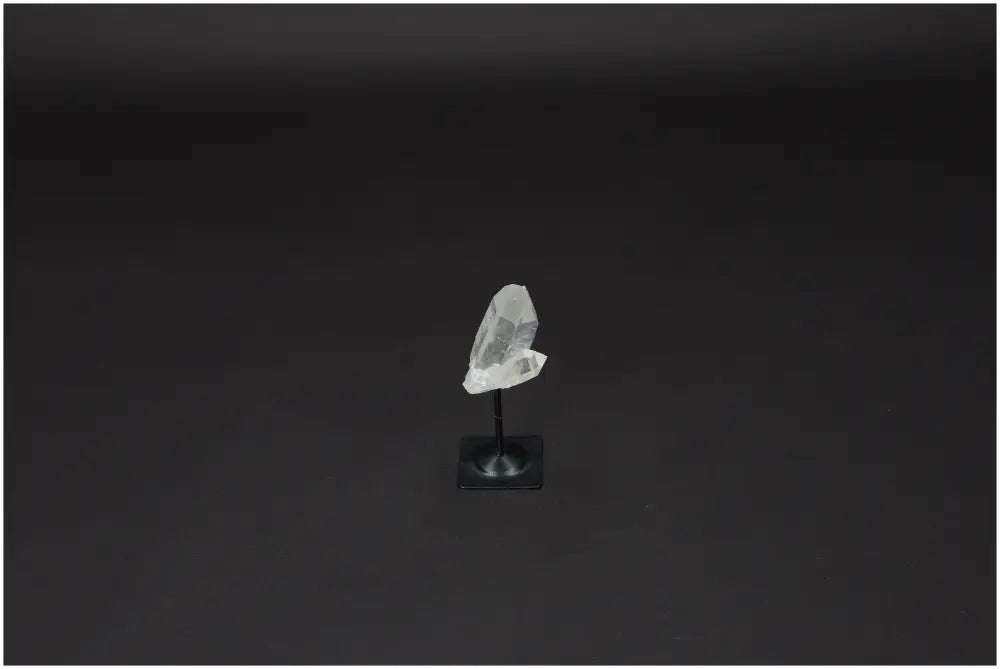 Lemurian Quartz on metal stand, showcasing its clarity and energy purification properties against a plain background.