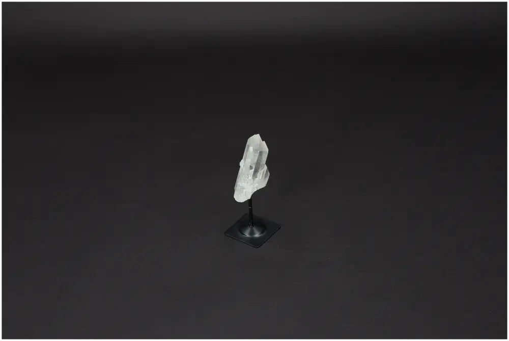 Lemurian Quartz crystal on a sleek metal stand, enhancing energy harmonization and space purification.