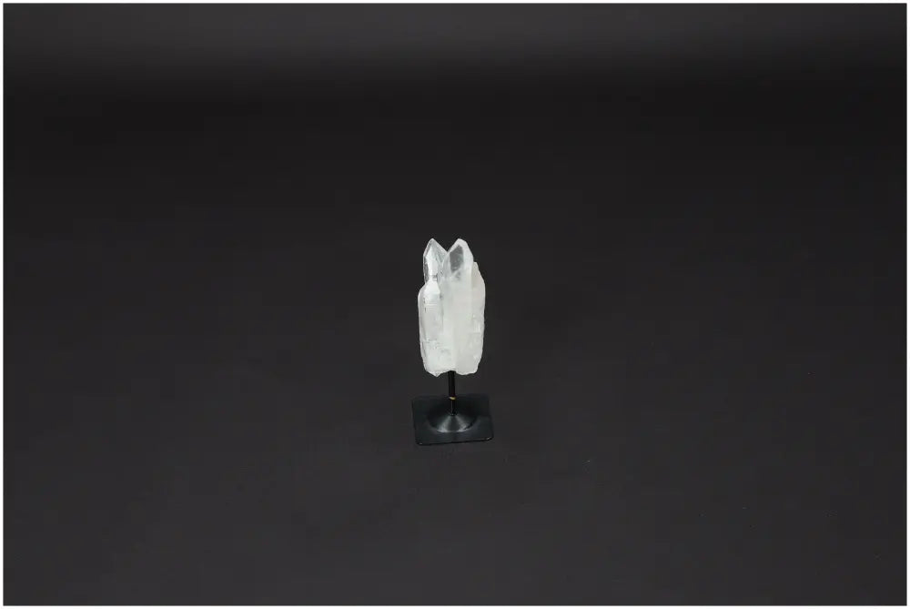 Lemurian Quartz on metal stand, known for purifying energy and neutralizing negativity, ideal for enhancing positive vibrations.
