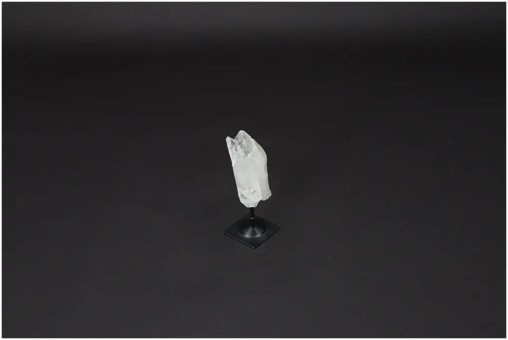 Lemurian Quartz on metal stand against dark background, known for purification and neutralizing negative energy. Ideal for daily use.