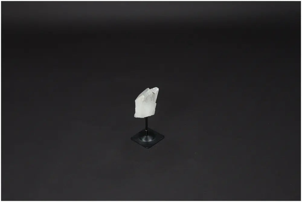 Lemurian Quartz on a sleek metal stand against a dark background, ideal for harmonizing and purifying space with powerful energy.