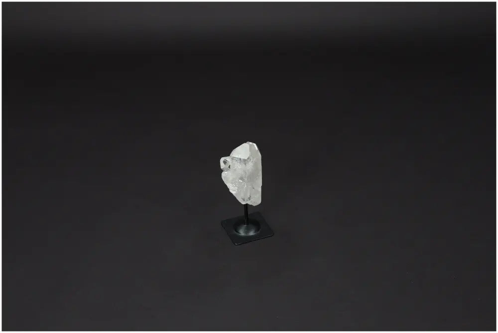 Lemurian Quartz on metal stand against dark backdrop, showcasing clarity and elegance, ideal for energy purification.