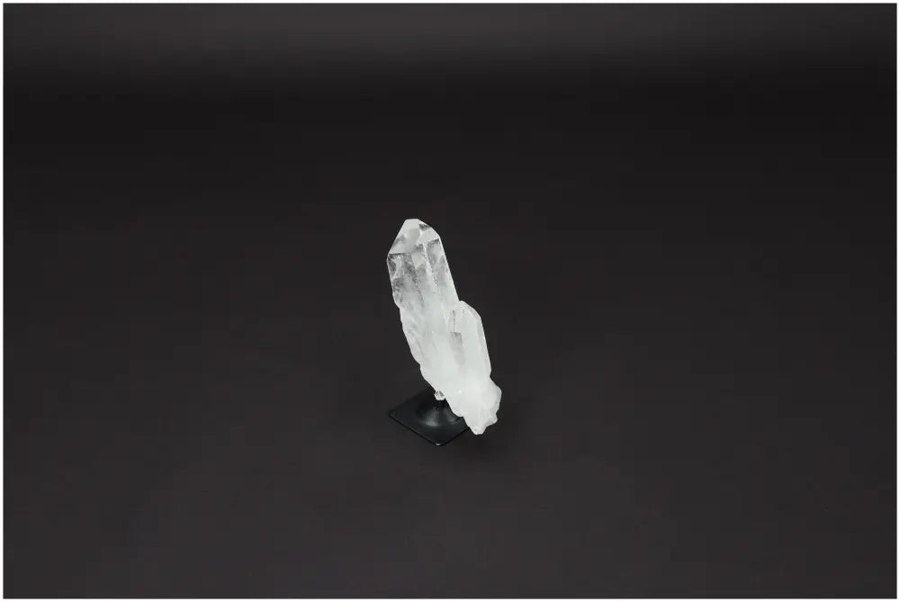 Lemurian Quartz crystal on metal stand offering powerful purification and harmonization of body, mind, and energy.