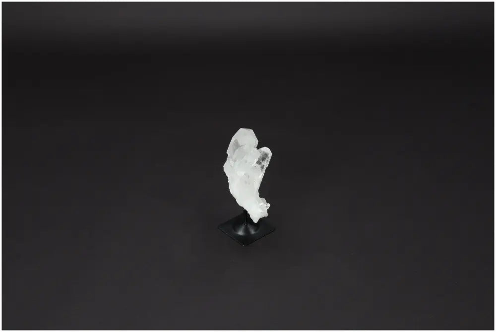 Lemurian Quartz on metal stand, known for purifying energy and neutralizing negative vibrations; ideal for harmonizing mind and space.