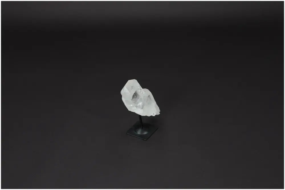 Lemurian Quartz Crystal on a sleek metal stand, ideal for purification and harmonizing energy by absorbing negative vibrations.