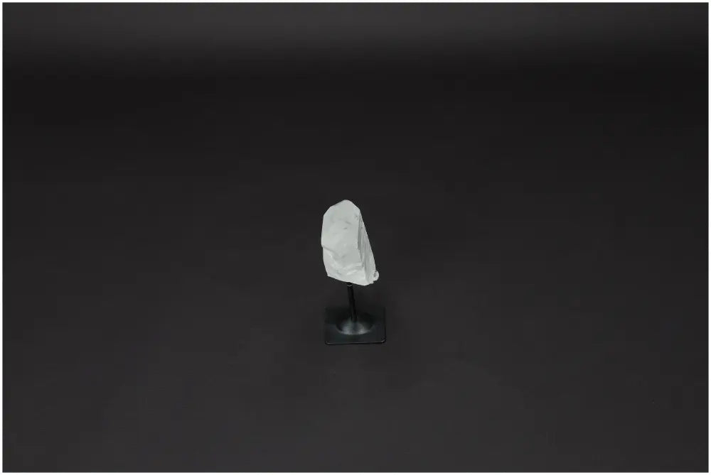 Lemurian Quartz on metal stand against dark background, ideal for energy purification and space cleansing.