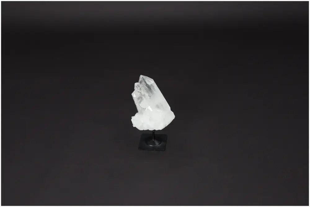 Lemurian Quartz crystal on a metal stand against a dark background, used for energy purification and harmonic balance.