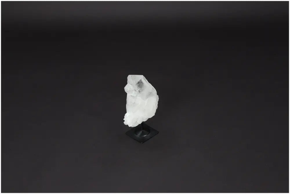Lemurian Quartz crystal on metal stand, known for purification, harmonizing body and energy, absorbing negative vibes and radiation.