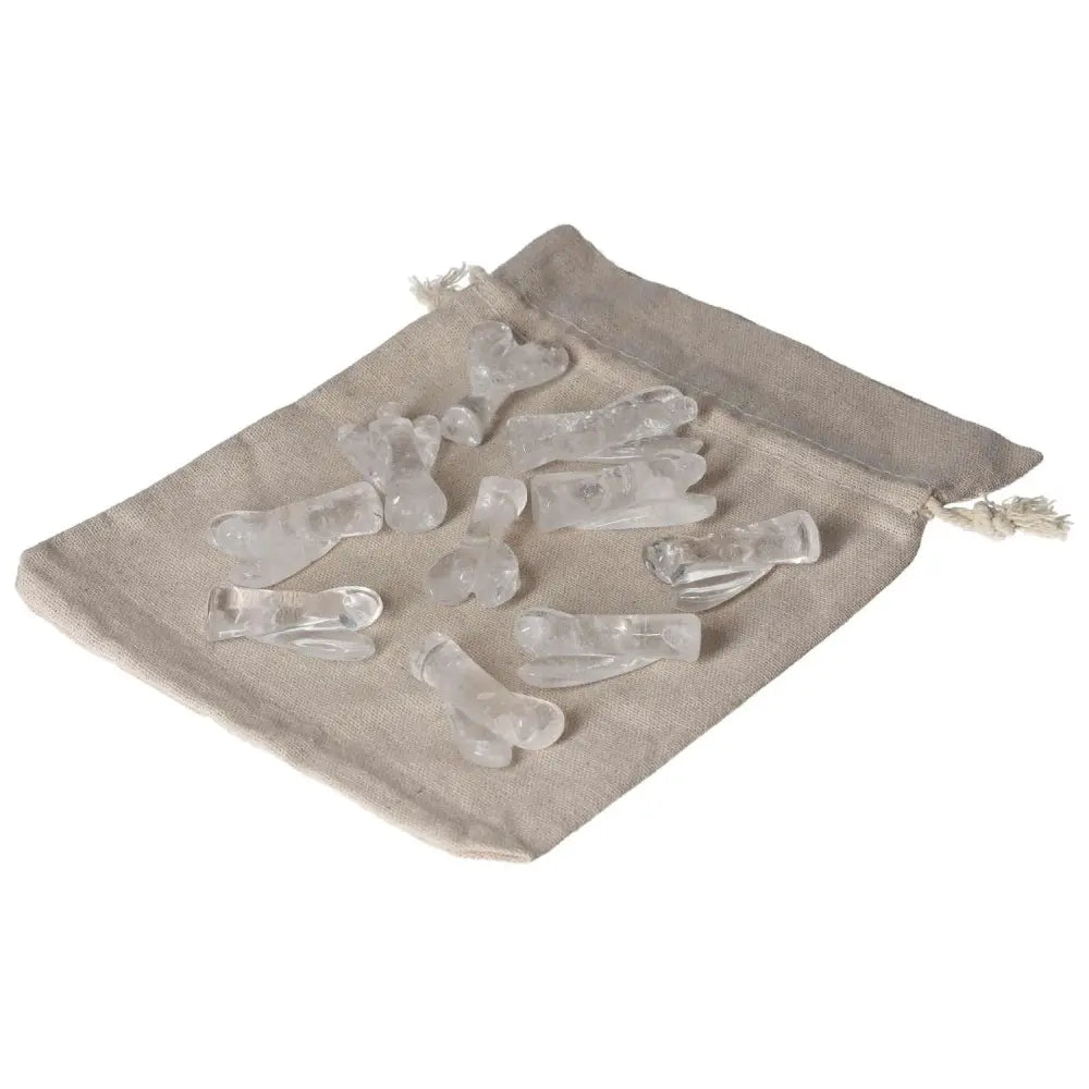 Clear Quartz Lemurian Small Angel crystals on a beige cloth bag for energy cleansing and purification.