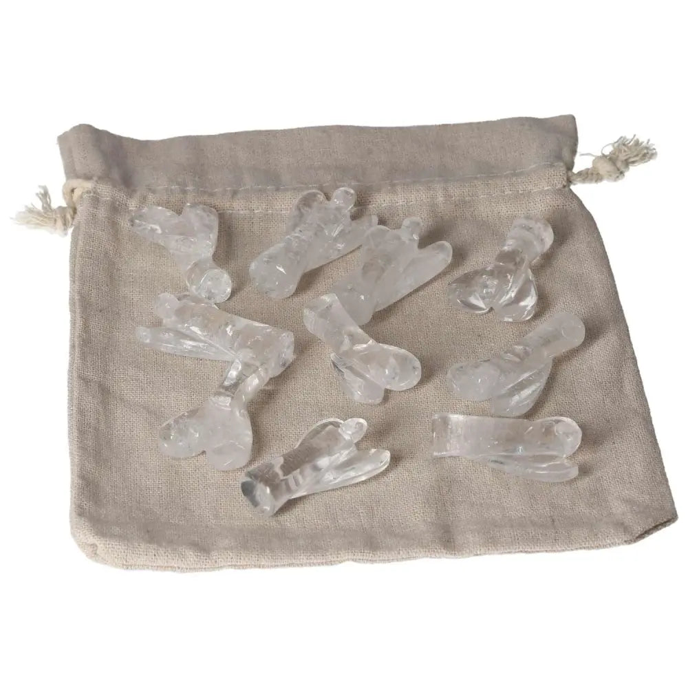 Collection of Lemurian Small Angel clear quartz crystals on a beige cloth bag, ideal for purification and harmonizing energy.