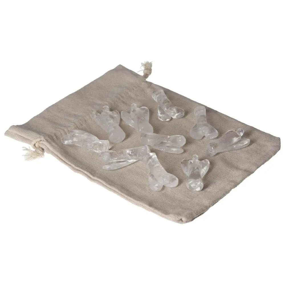 Lemurian Small Angel Clear Quartz figurines on linen pouch, promoting purification and energy harmonization.