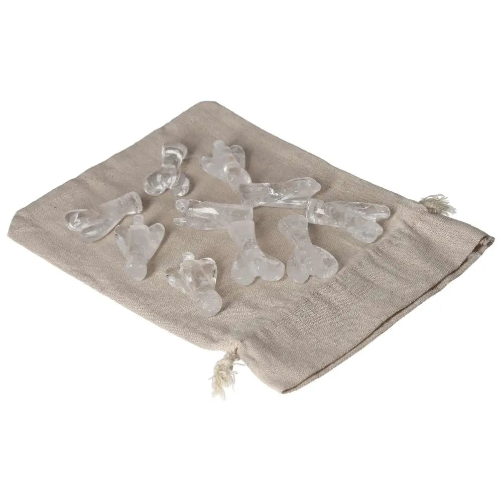 Clear Quartz Lemurian Small Angel stones on beige cloth, promoting purification and energy harmony, ideal for everyday use.