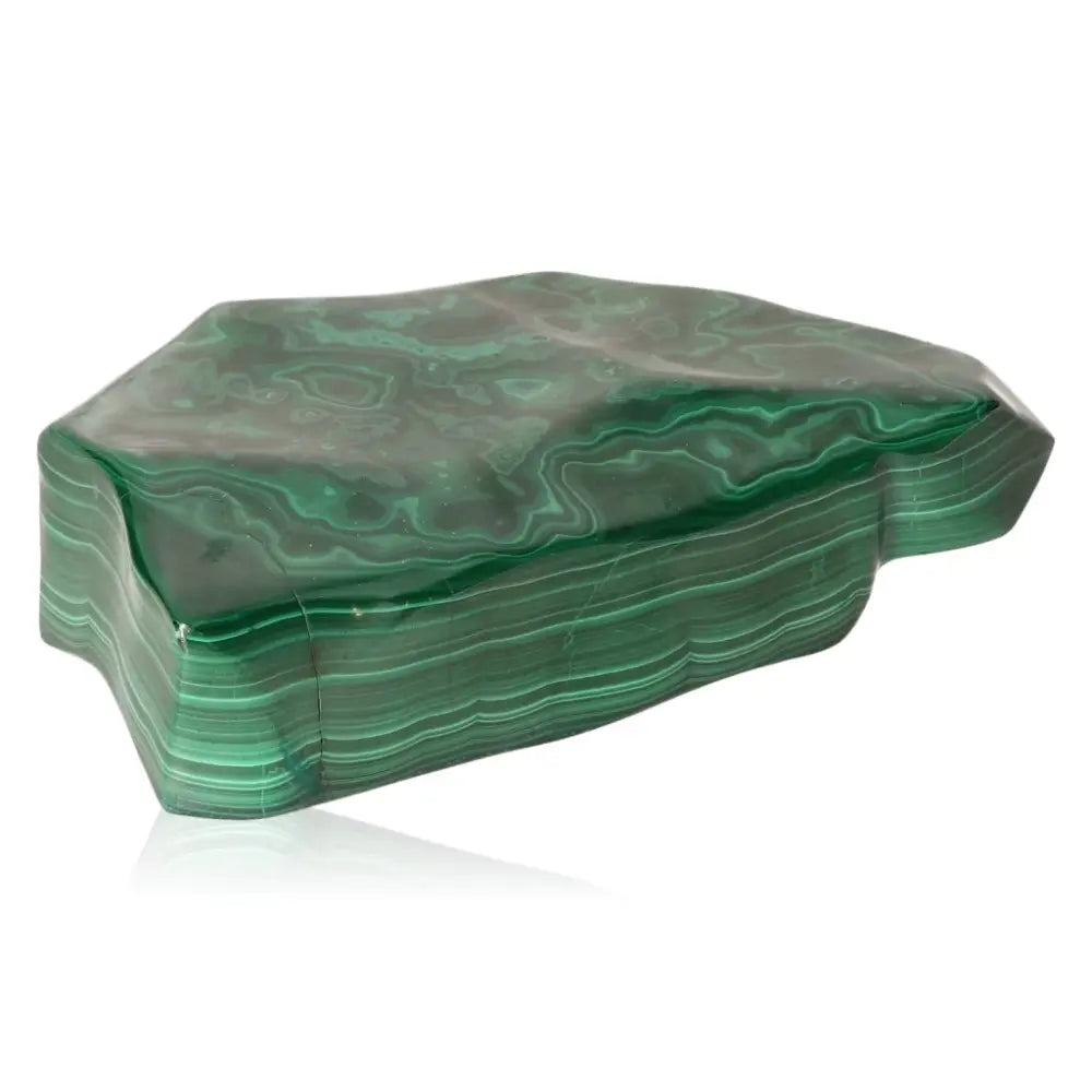 Polished malachite stone showcasing natural green bands, symbolizing tranquility and courage as a personal talisman.