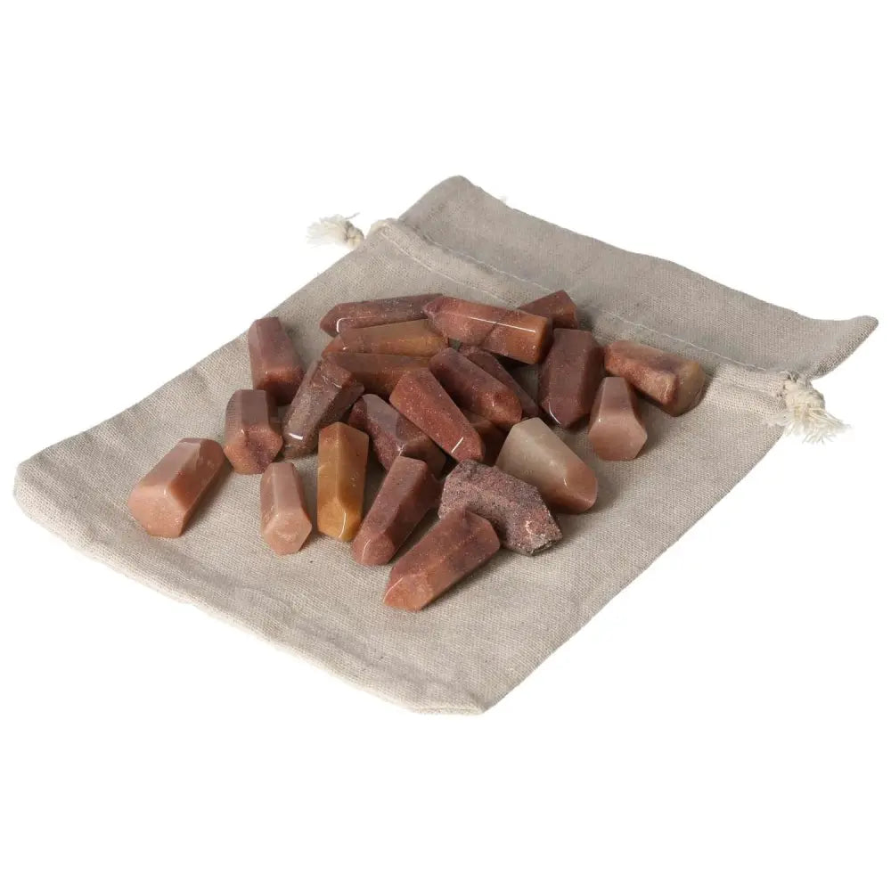 Mini Point Red Quartz Crystals 1 KG, 25 PCS, enhancing chakras and spiritual energy, on a beige pouch.