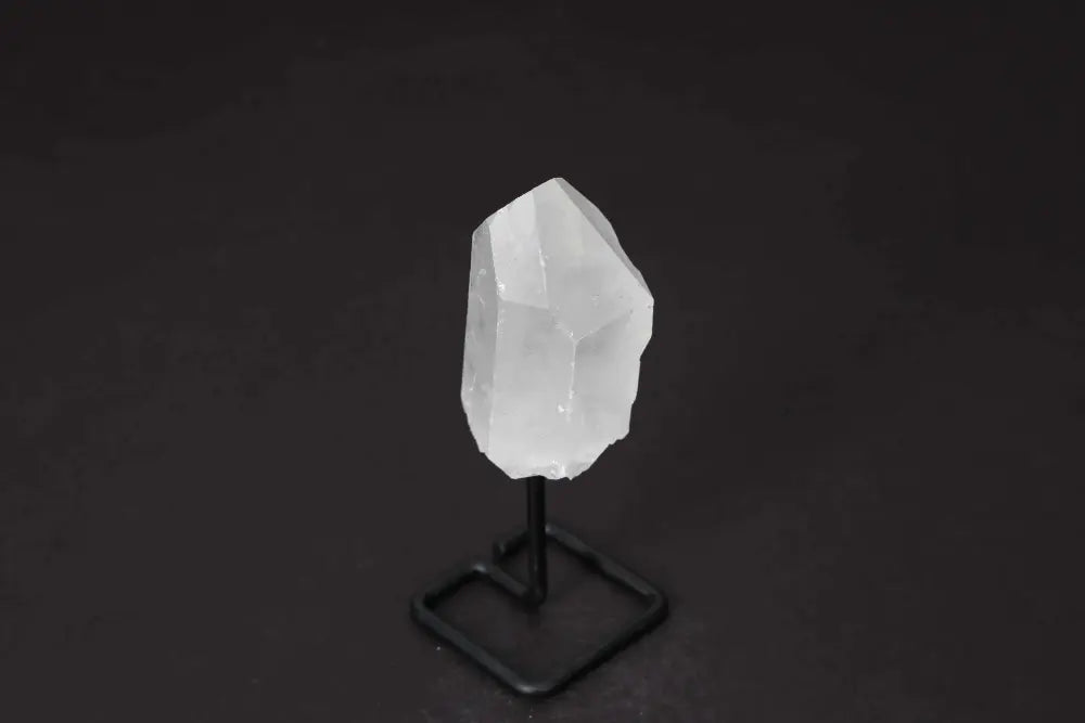 Natural Clear Quartz Point on modern stand, enhances energy and clarity, ideal for meditation and manifestation.