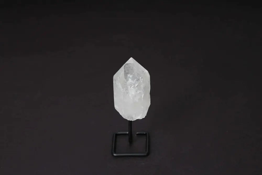Natural Clear Quartz Point on modern stand for energy amplification and clarity, ideal for meditation and manifestation.