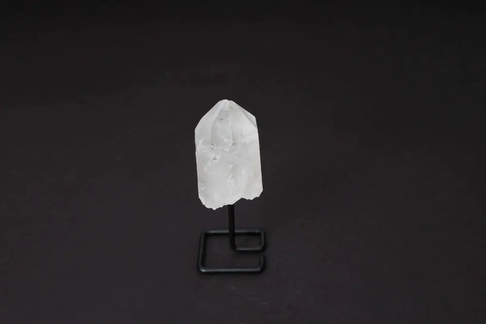 Natural Clear Quartz Point on Stand, ideal for energy amplification and clarity in meditation or decor.