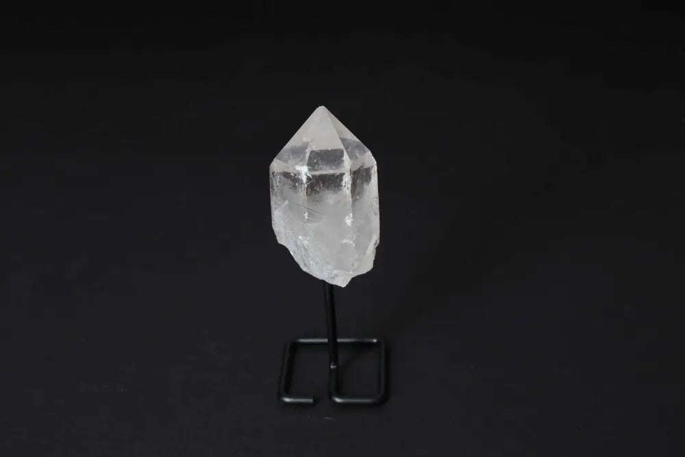 Clear Quartz Point on modern stand, known as Master Healer, for energy amplification and meditation. Ideal centerpiece for any space.