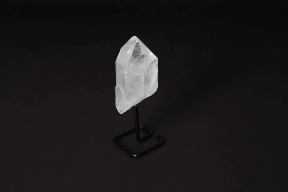Clear Quartz Point on stand, ideal for amplifying energy and clarity, stylishly displayed for meditation and energy work.
