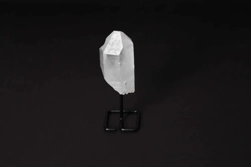 Natural Clear Quartz Point on modern stand, perfect for amplifying energy, clarity, and focus in meditation or energy work.