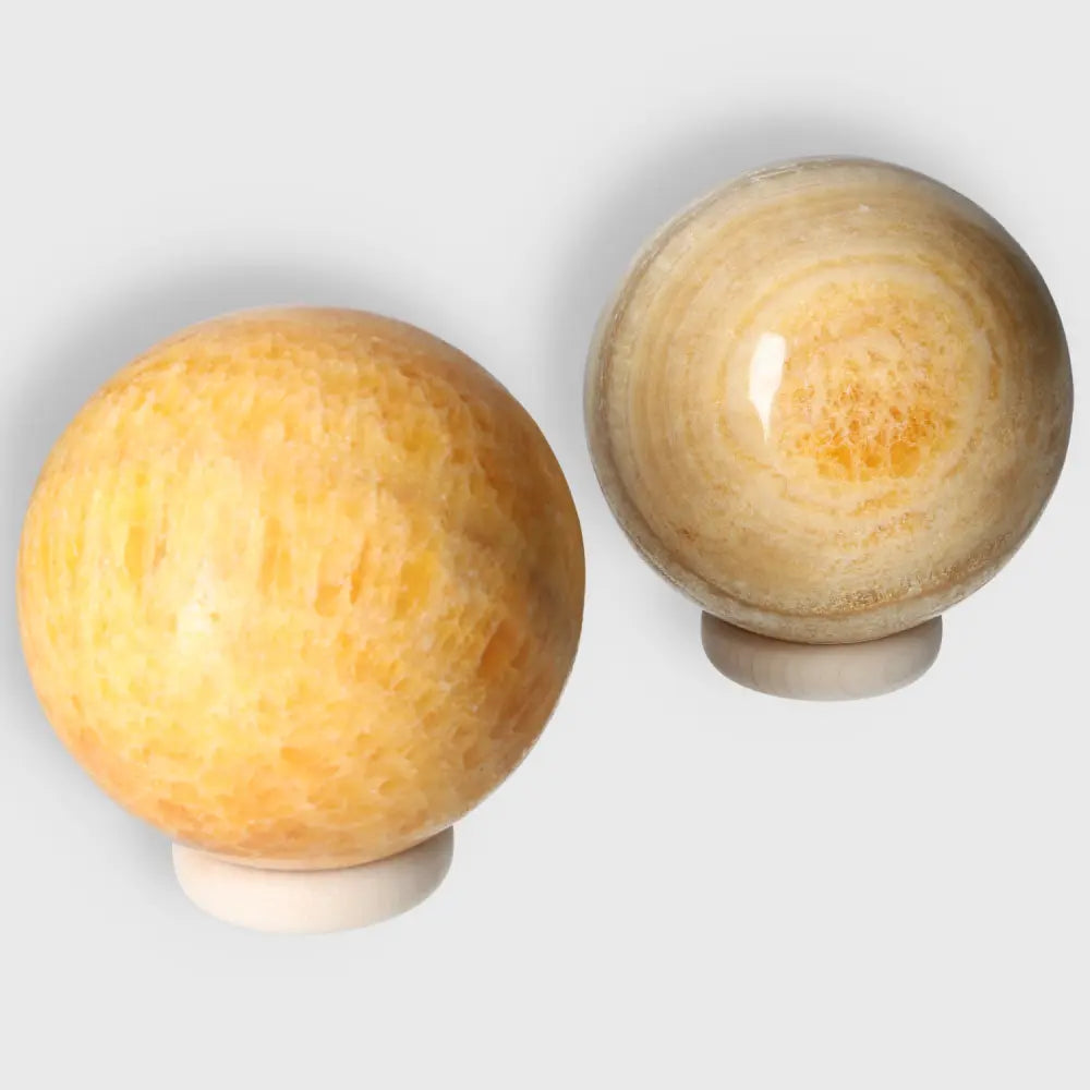 Two vibrant Orange Calcite Spheres radiating positivity and creativity, perfect for emotional healing and balance in sacred spaces.