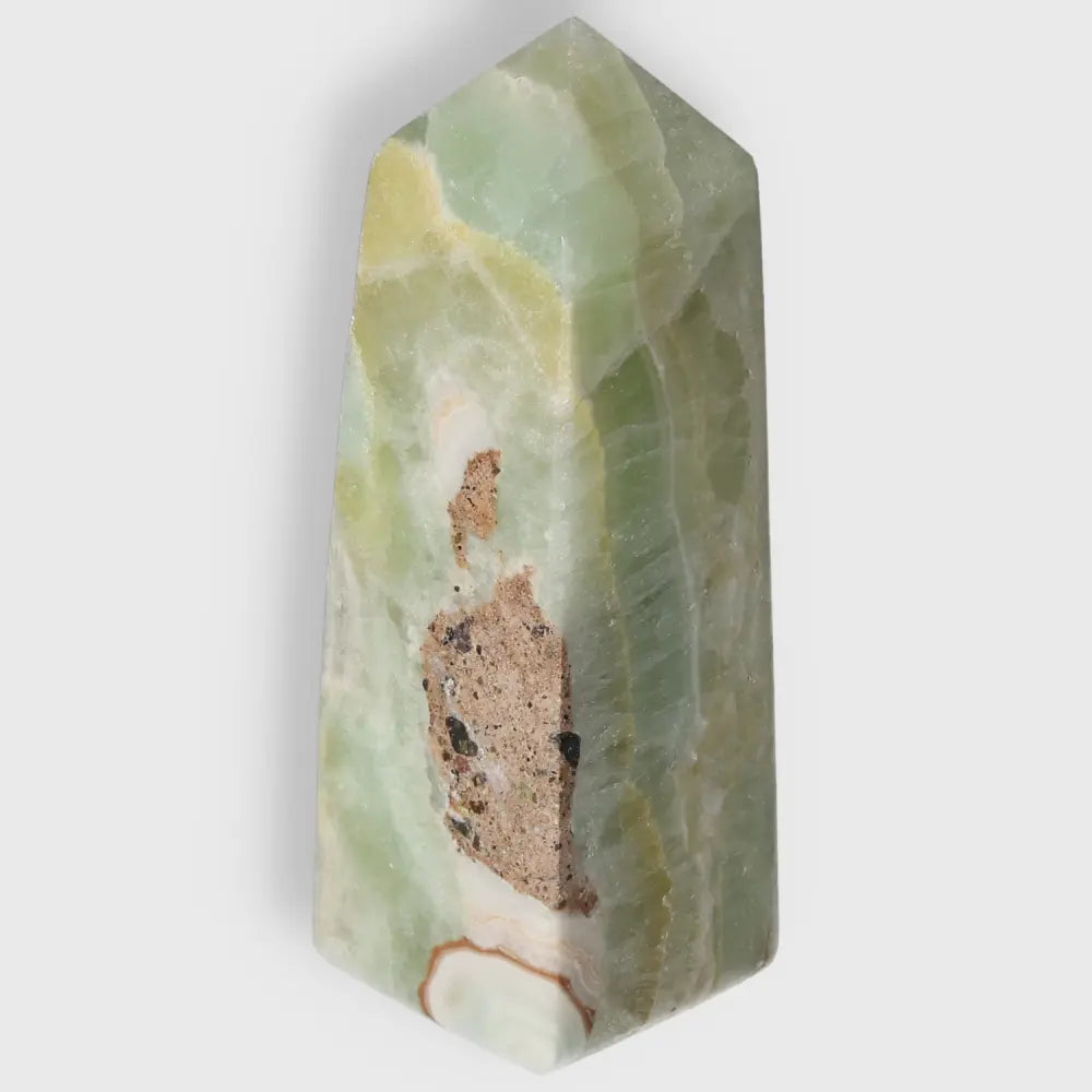 Pistachio Calcite Tower with soothing green hues for balance and harmony, showcasing natural artistry and metaphysical properties.