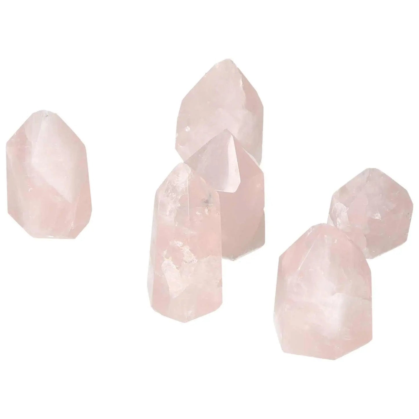 Collection of small polished rose quartz obelisks by Sylvia Crystals, enhancing energy flow and aesthetic appeal.