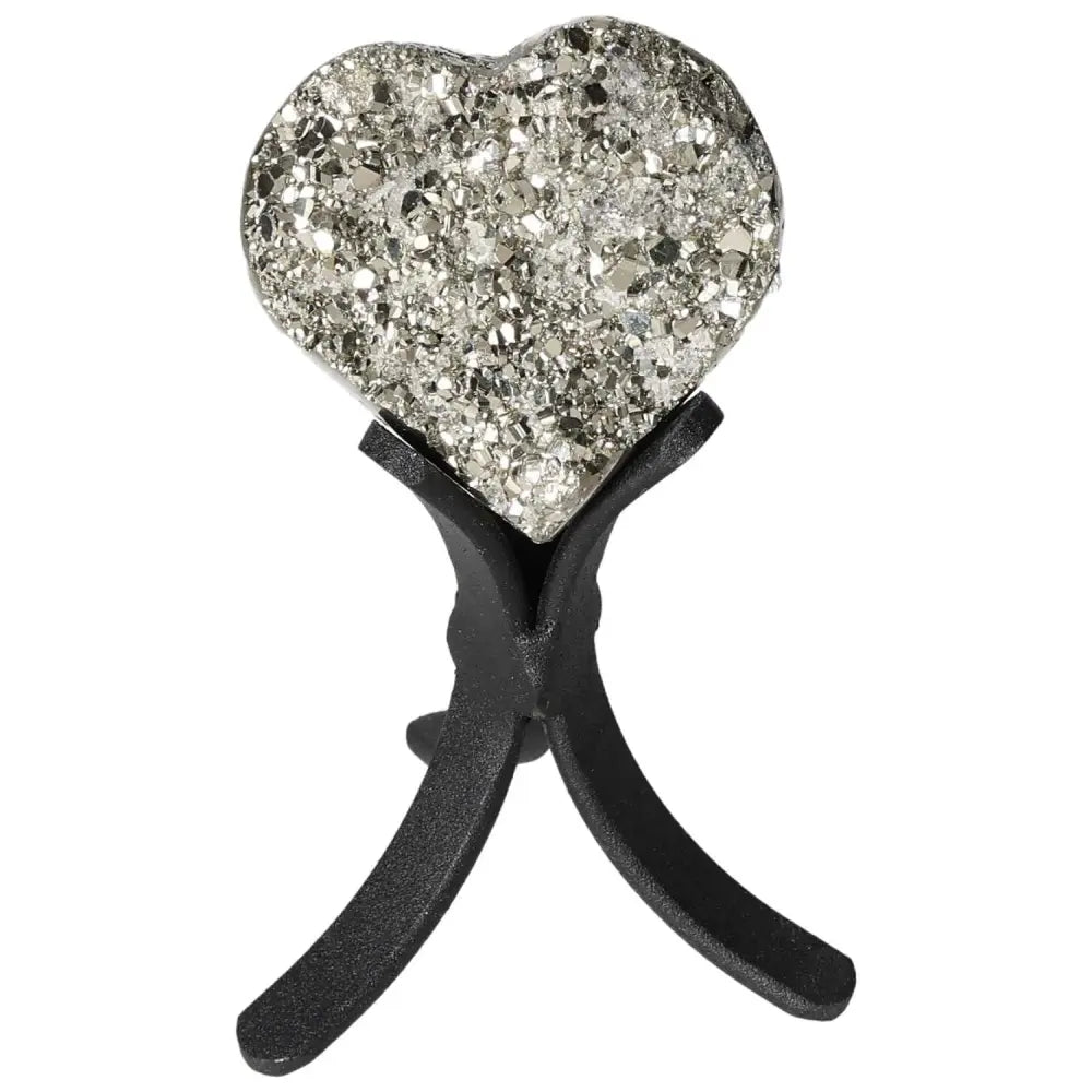Polished pyrite heart shape with golden luster on display stand, reflecting radiant energy and elegance.