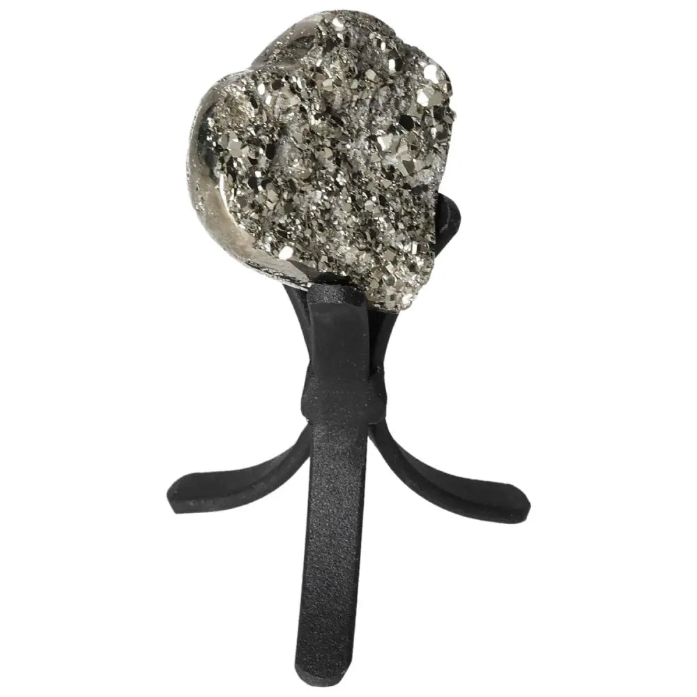 Polished pyrite heart shape on display stand, showcasing golden luster and grounding energy.
