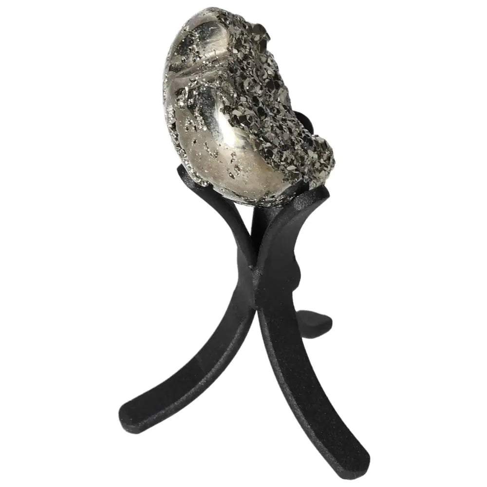 Polished pyrite heart on display stand, showcasing its golden luster and grounding energy ideal for home decor and spiritual spaces.