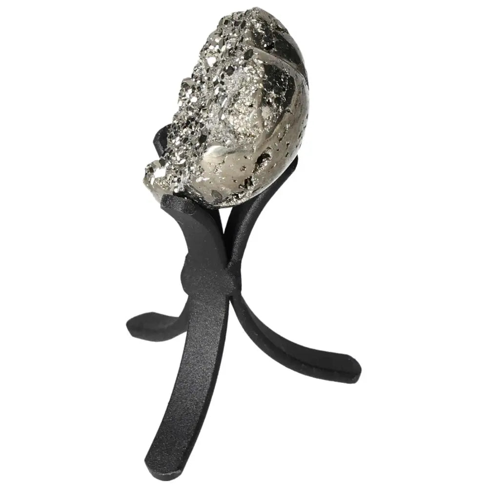 Polished pyrite heart on black stand showcasing golden luster and unique texture for radiant energy.