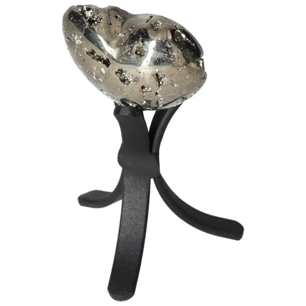 Polished pyrite heart with golden luster displayed on black stand, showcasing radiant energy and grounding power.