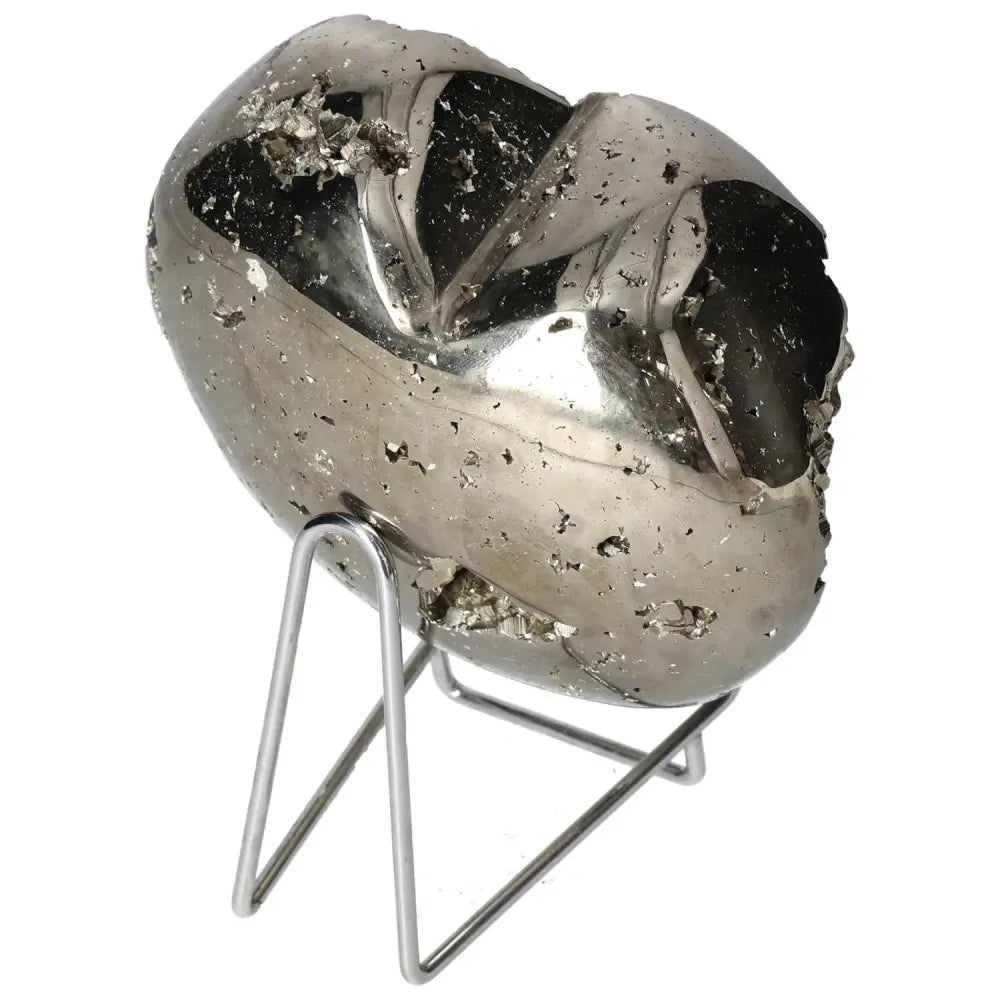 Polished pyrite heart on stand showcasing golden luster and grounding energy.