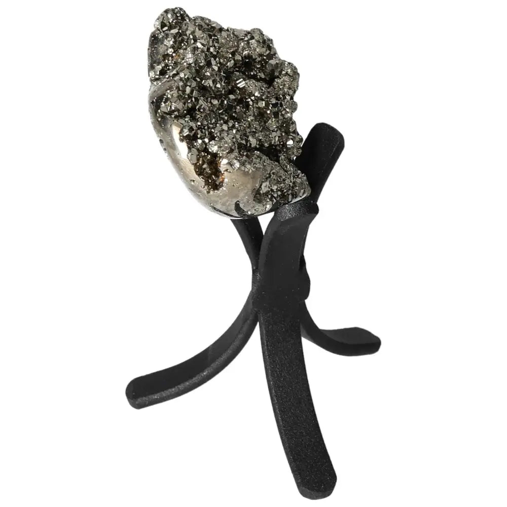 Polished pyrite heart displayed on a stand, showcasing golden luster and grounding energy.
