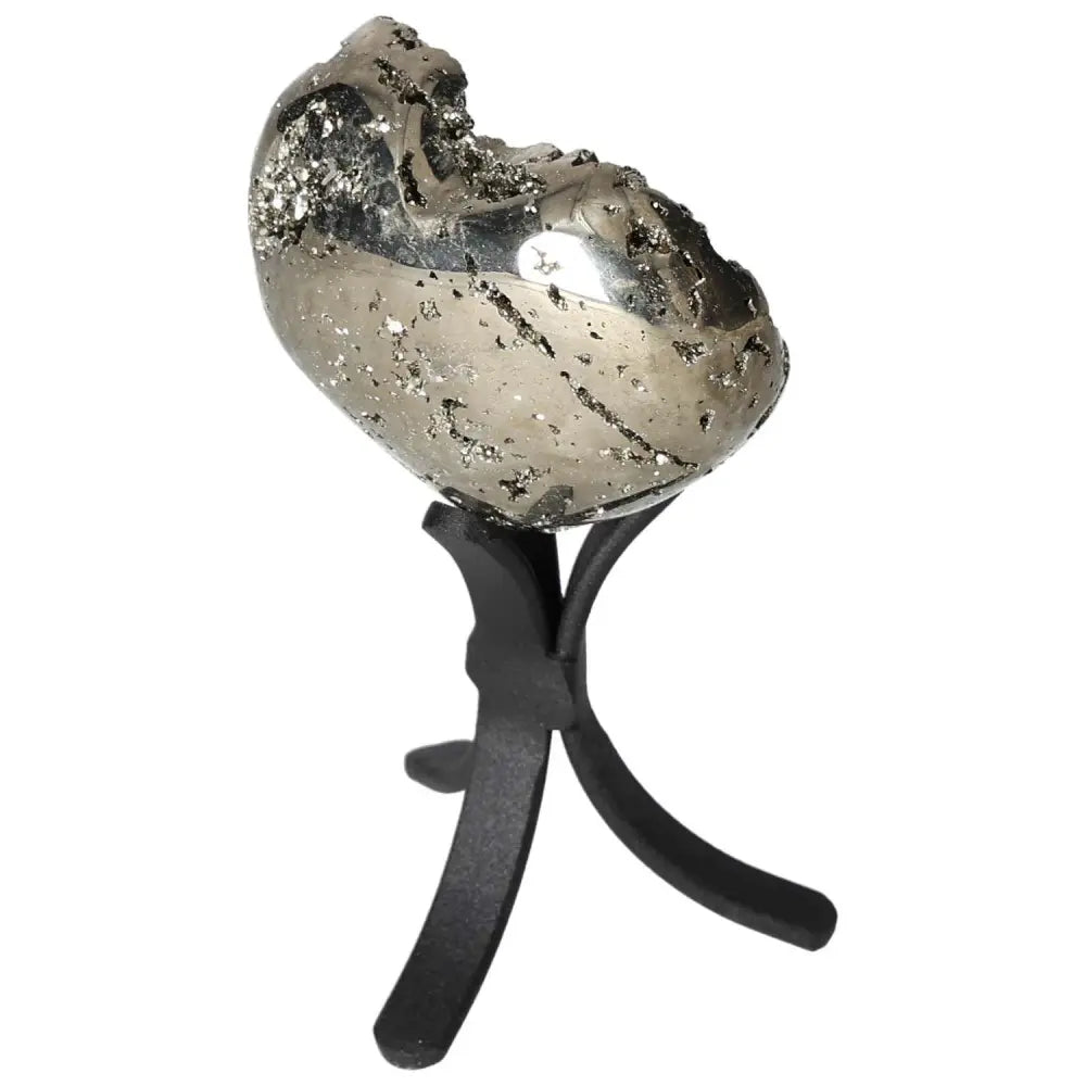 Polished pyrite heart sculpture on black stand, showcasing golden luster and grounding energy, perfect for elevating space.