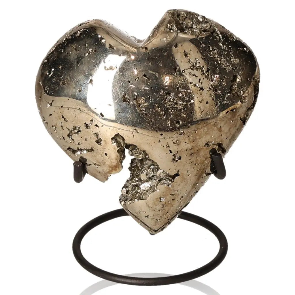 Heart-shaped Pyrite stone with metallic luster, symbolizing prosperity and abundance, on a display stand.