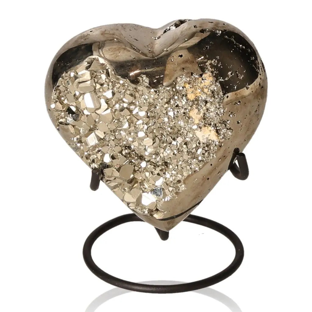 Heart-shaped pyrite mineral with metallic luster, symbolizing abundance and prosperity, displayed on a stand