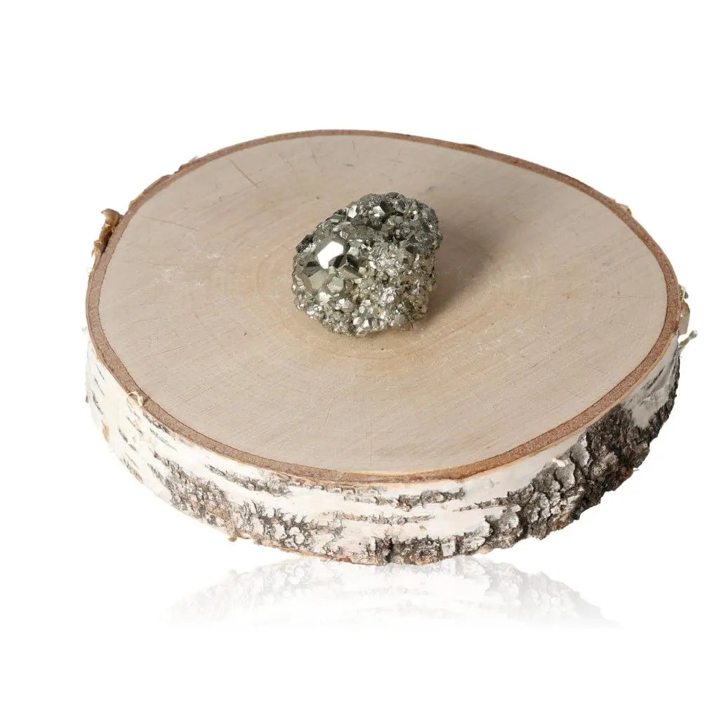 Pyrite druzy on wooden slice showcasing natural golden hue and metallic luster, symbolizing abundance and prosperity.