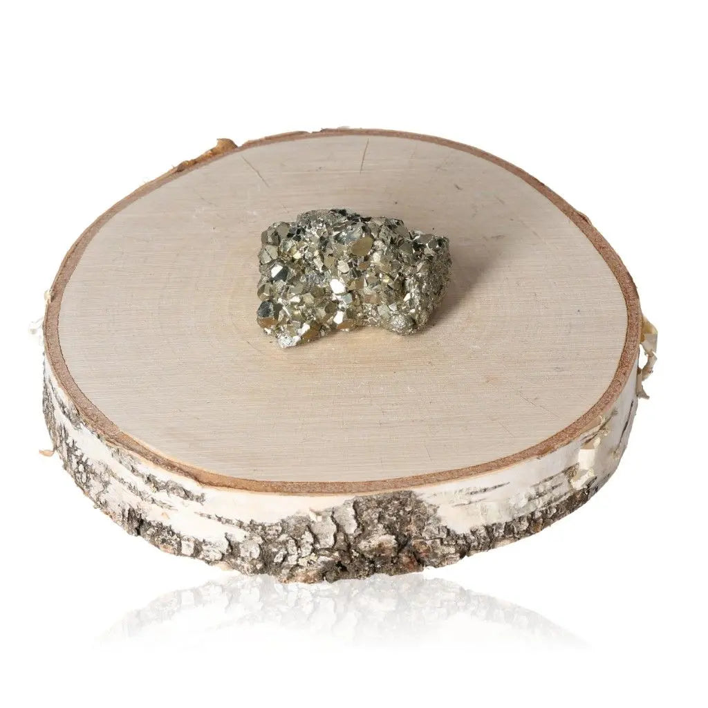 Pyrite druze with golden hue on wooden slab, known as Fool's Gold, symbolizes abundance and prosperity.