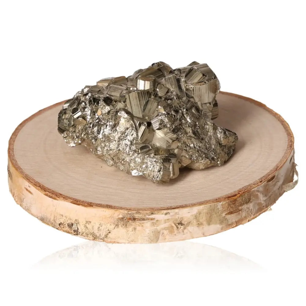 Pyrite druzy stone on wooden slice, showcasing its golden hue and metallic luster, symbolizing abundance and prosperity.
