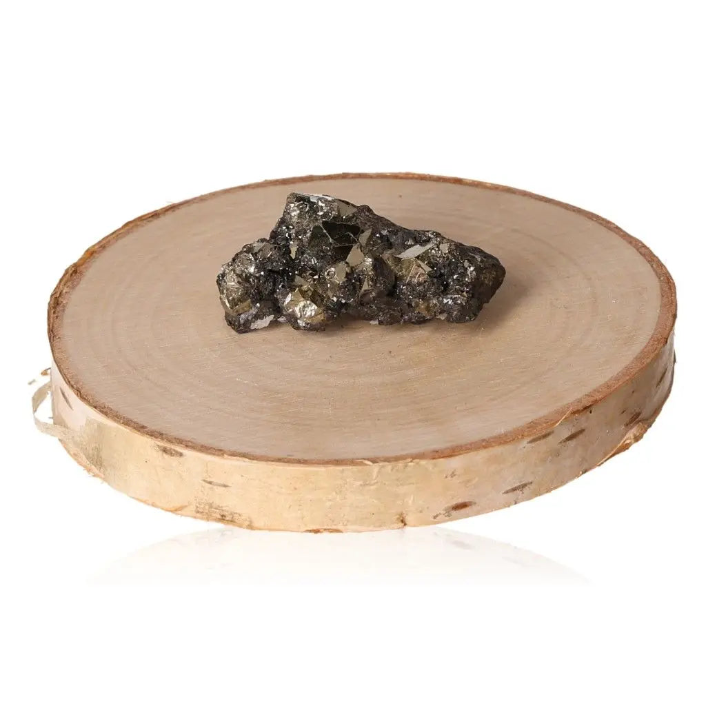 Natural pyrite druze on a wooden display, showcasing its golden metallic shine and crystalline structure. Known as Fool's Gold.