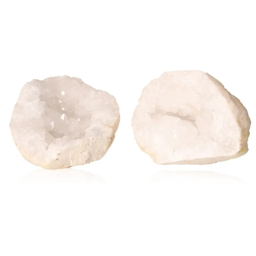 Quartz geode pair with sparkling crystal interior, showcasing natural beauty and rugged exterior.