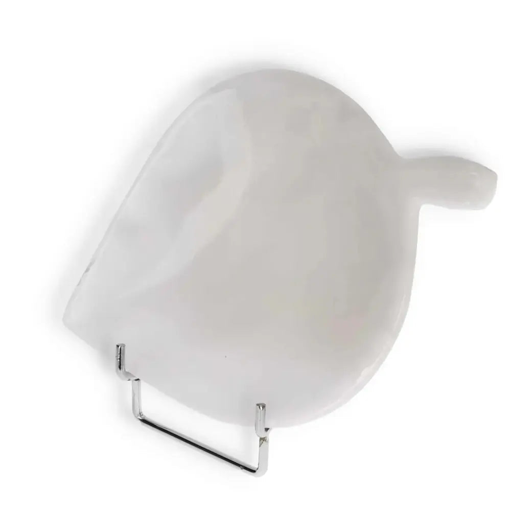 White pearl-shaped onyx platter with a smooth, polished surface on a display stand, showcasing elegant design and unique veining.