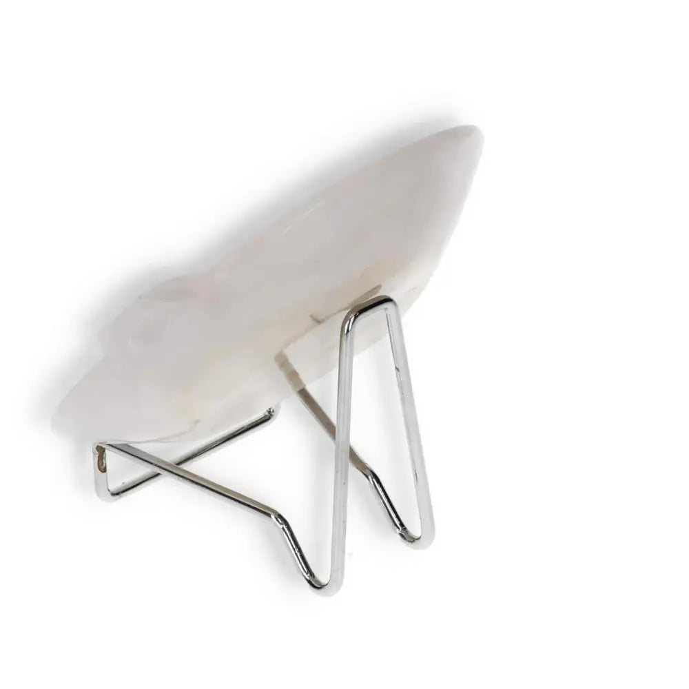 Side view of a rose onyx platter on a metal stand, highlighting the unique natural patterns and smooth polished surface