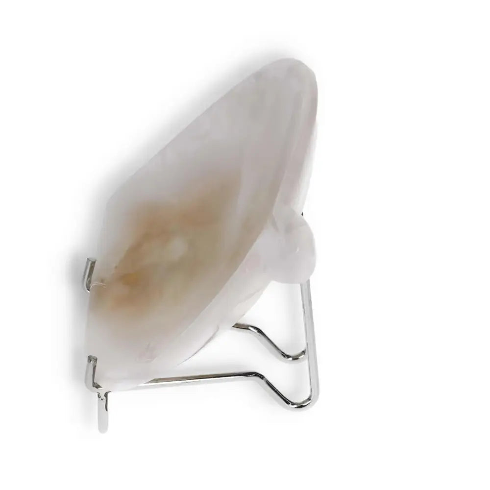 Side view of a rose onyx platter with natural veining and smooth finish, displayed on a metal stand.