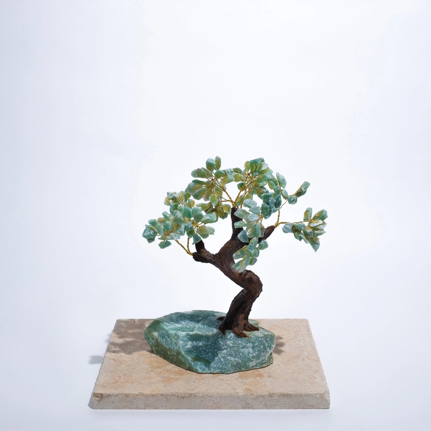 Rough aventurine crystal bonsai tree on stone base, promoting prosperity, harmony, and positive energy. Handcrafted ornamental decor.